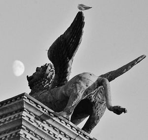 Low angle view of angel statue against clear sky