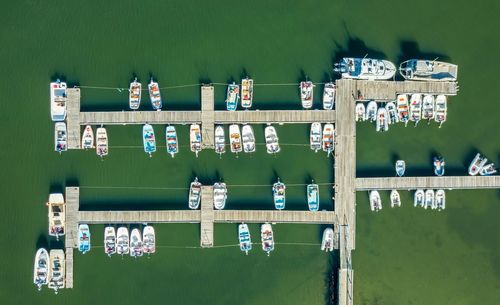 High angle view of boats moored at harbor in green sea