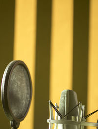 Close-up of microphone against wall