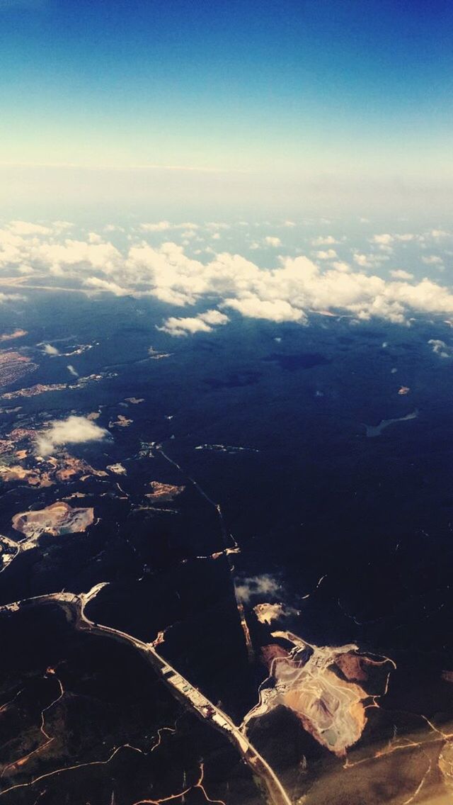 aerial view, scenics, water, tranquil scene, beauty in nature, tranquility, sky, nature, landscape, sea, blue, idyllic, no people, outdoors, high angle view, day, cloud, cloud - sky, mountain, lake