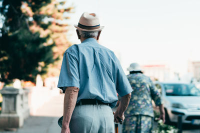 Rear view of man standing in city