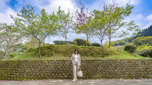 Man standing by plants against sky