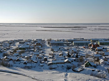 Aerial view of frozen sea against clear sky