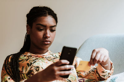 Ethnic woman shopping online at home