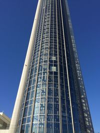 Low angle view of modern building against clear blue sky