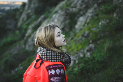 Teenage backpack girl hiking on mountain