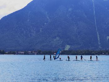 Group of people on mountain by lake