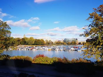 Scenic view of river by trees against sky