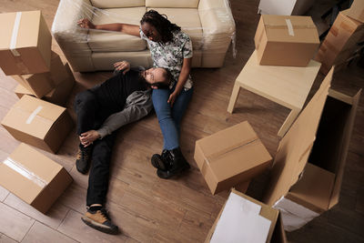 Man lying on girlfriend's lap on floor at home