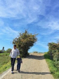 Silhouette of woman standing on tree against blue sky