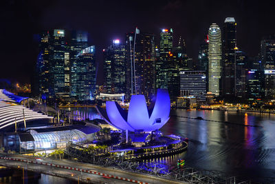 Illuminated modern buildings in city at night