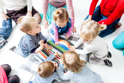 High angle view of kids on floor