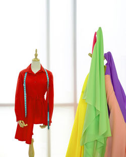 Close-up of multi colored umbrellas hanging on window