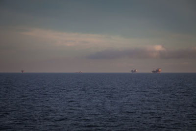 Scenic view of oil platform in the adriatic sea against sky during sunset