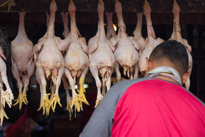 Midsection of man for sale at market stall