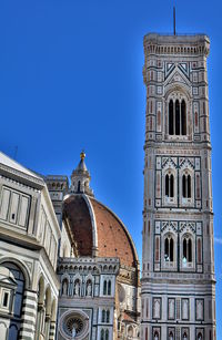 Low angle view of building against clear blue sky