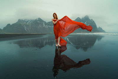 Beautiful woman in red dress on reynisfjara beach scenic photography