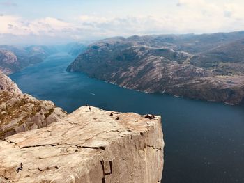Scenic view of sea and mountains against sky