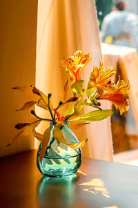 Close-up of orange flower vase on table