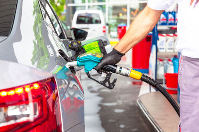 Filling diesel fuel in car at gas station