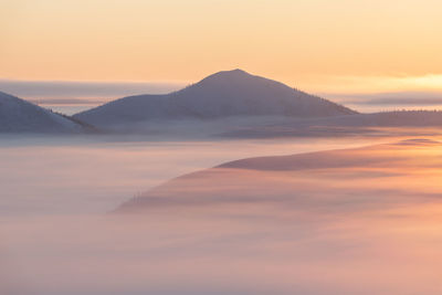 Scenic view of mountains against sky during sunset