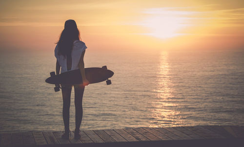 Beautiful young girl with her skateboard