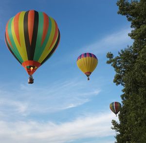 Low angle view of hot air balloons flying in sky