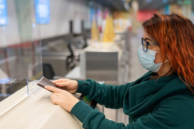 Side view of woman using mobile phone