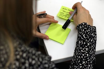 High angle view of woman working on paper