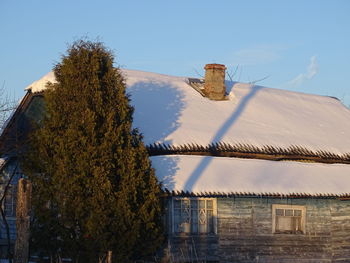 Low angle view of old roof and building against sky