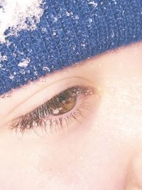 Cropped image of person wearing snow covered knit hat