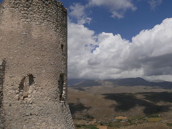 Scenic view of mountain against cloudy sky