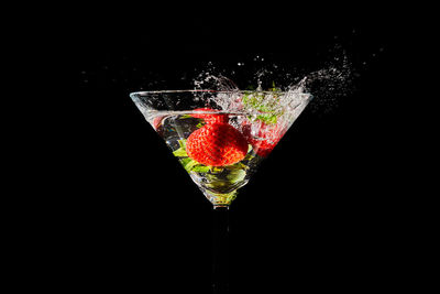 Close-up of wine glass against black background