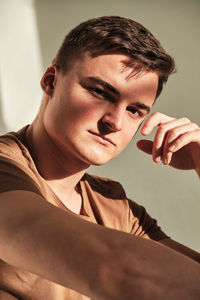 Handsome young man in t-shirt and jeans alone