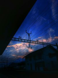 Low angle view of power lines against sky