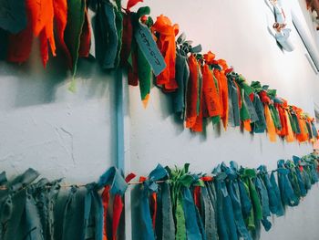 Ribbons hanging on string against wall