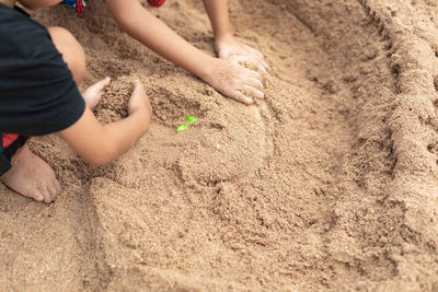 Low section of child playing with sand