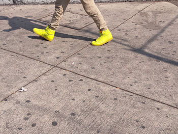 Low section of person standing on footpath