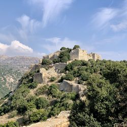 Castle on mountain against sky