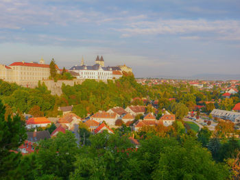 High angle view of buildings in town against sky