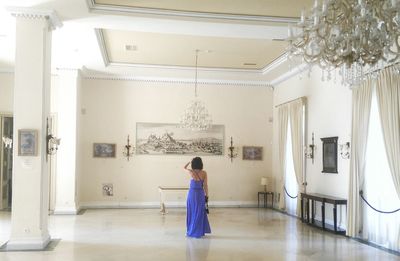 Rear view of young woman standing in corridor