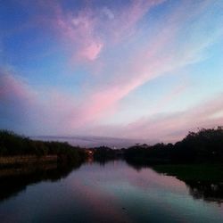 Scenic view of lake against sky at sunset