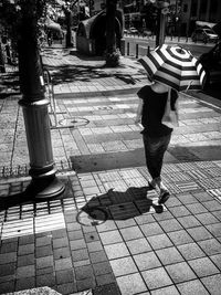 Woman standing on sidewalk