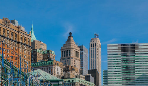 Low angle view of buildings against blue sky