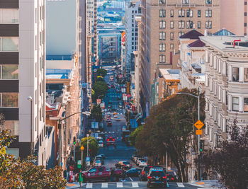 Cars on street amidst buildings in city