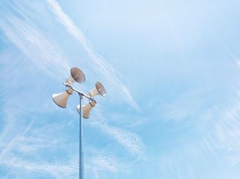 Low angle view of balloons against blue sky