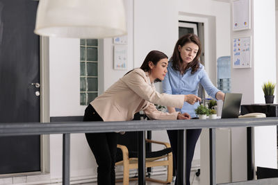 Portrait of female doctor explaining to daughter