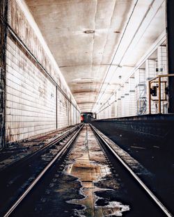 Railroad tracks in illuminated tunnel
