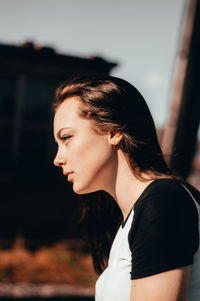 Side view of young woman looking away