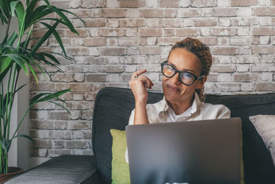 Young man using laptop while sitting at home